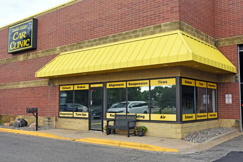 Apple Valley Car Clinic storefront with a yellow awning and service signs in the windows at 7540 147th St W, Apple Valley, MN