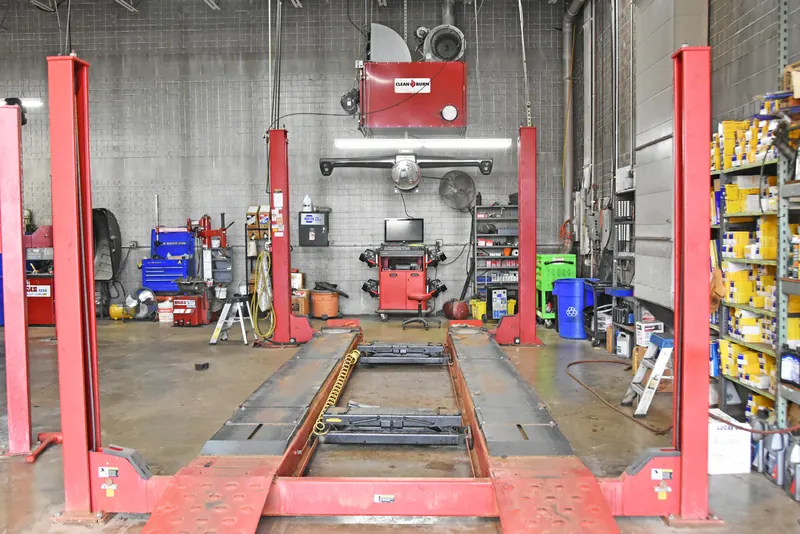 Wheel alignment bay with a lift rack and alignment machine inside Apple Valley Car Clinic